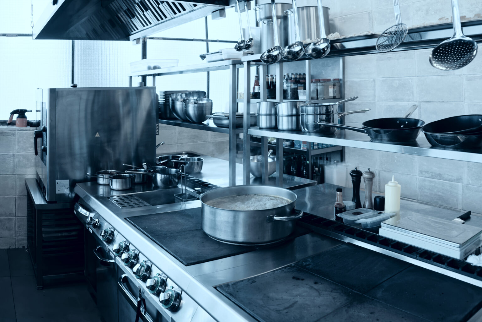 Professional kitchen interior, crock on stove, toned image